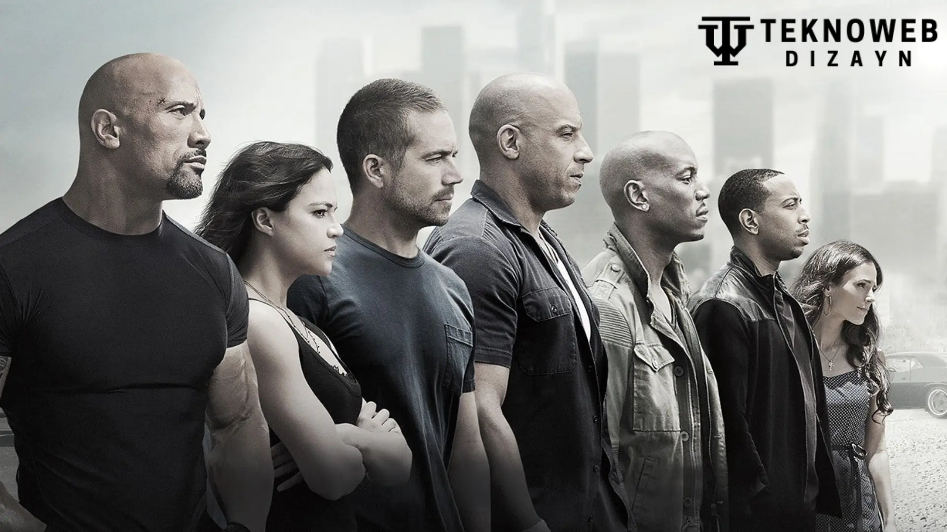 Fast and Furious Cast: A lineup of the iconic Fast and Furious cast members, including actors known for their action-packed roles and strong on-screen camaraderie, set against an urban backdrop.