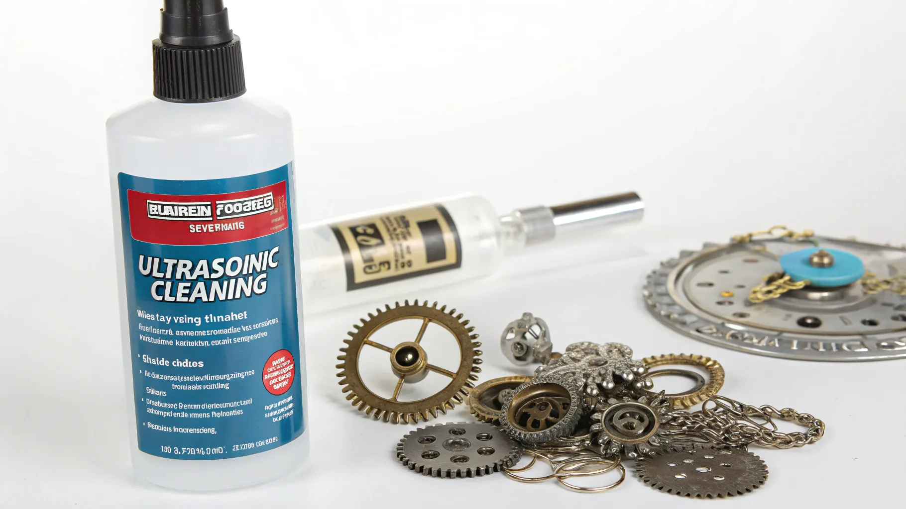 Bottle of ultrasonic cleaning solution placed next to gears and mechanical parts, ideal for cleaning in Harbor Freight.